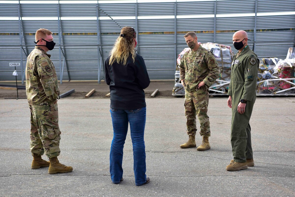 U.S. Air Force Col. David Berkland, the 354th Fighter Wing (FW) commander, and Chief Master Sgt. John Lokken, the 354th FW command chief, talk to 2nd Lt. Chance Wessel, the 354th Logistics Readiness Squadron (LRS) assistant installation deployment officer, and Holly Kinsey, the 354th LRS installation deployment officer at Eielson Air Force Base, Alaska, Sept. 15, 2020.