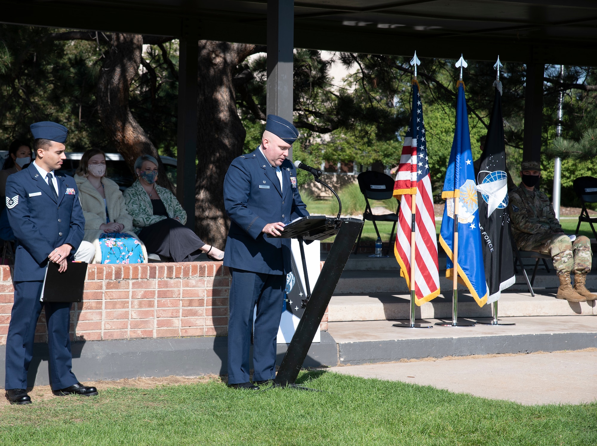 Colonel speaking to Airman and visitors at ceremony