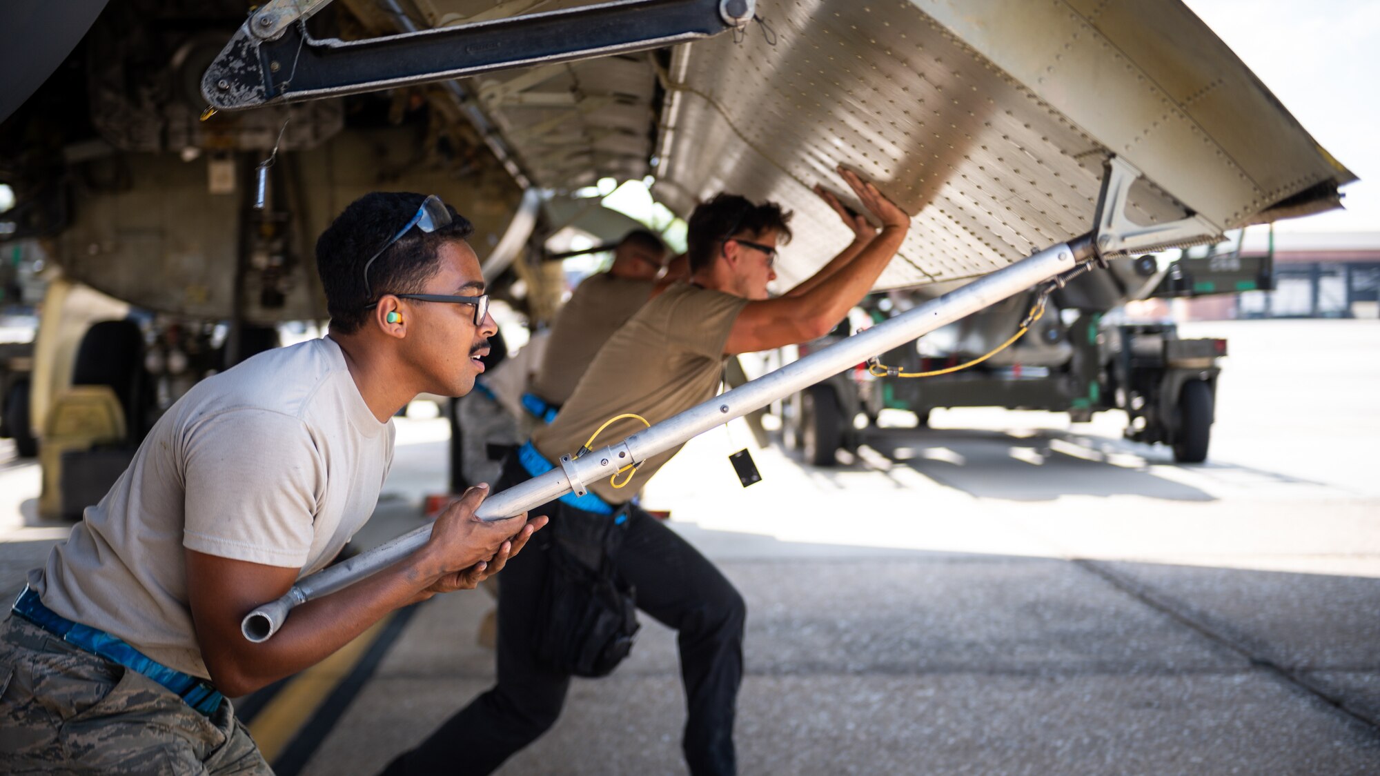 Senior Airman Timothy Pierce, 20th Aircraft Maintenance Unit weapons load crew member, lifts a B-52H Stratofortress bomb bay door at Barksdale Air Force Base, La., at Barksdale Air Force Base, La., Aug. 24, 2020. The equipment for testing is attached to the warhead and is able to record timing and voltages across the warhead, missile and the aircraft. (U.S. Air Force photo by Senior Airman Lillian Miller)