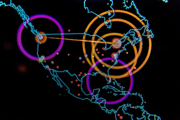 A graphic, computer-generated line map of the world highlights points of cyber activity.