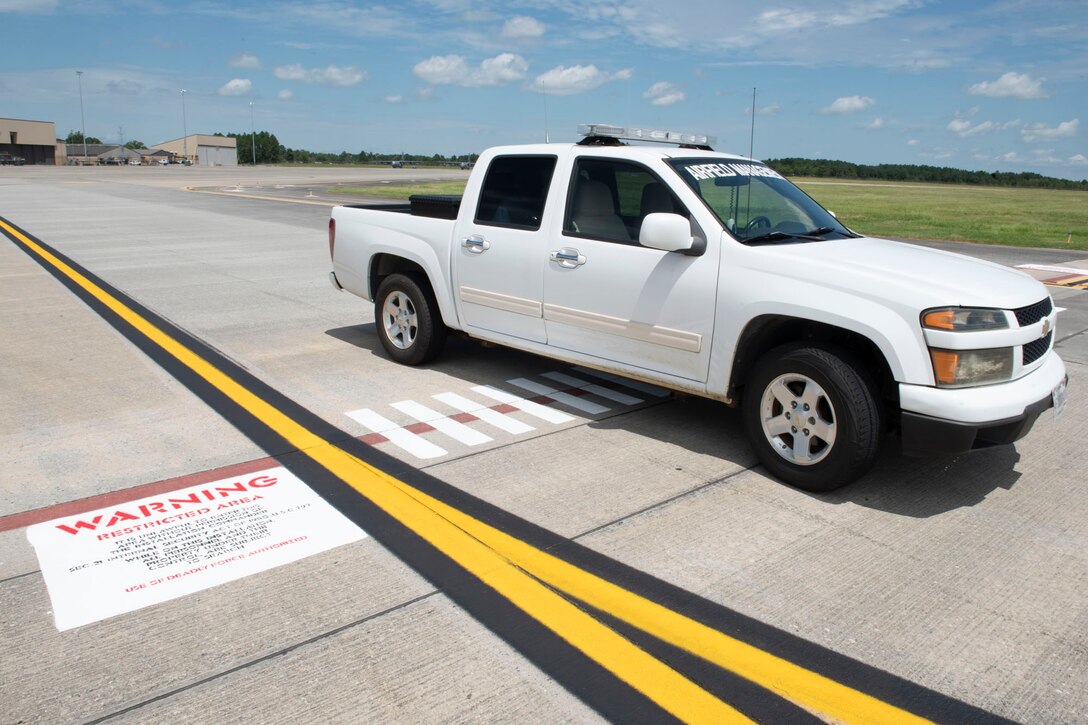 Photo of an Airman checking the runway