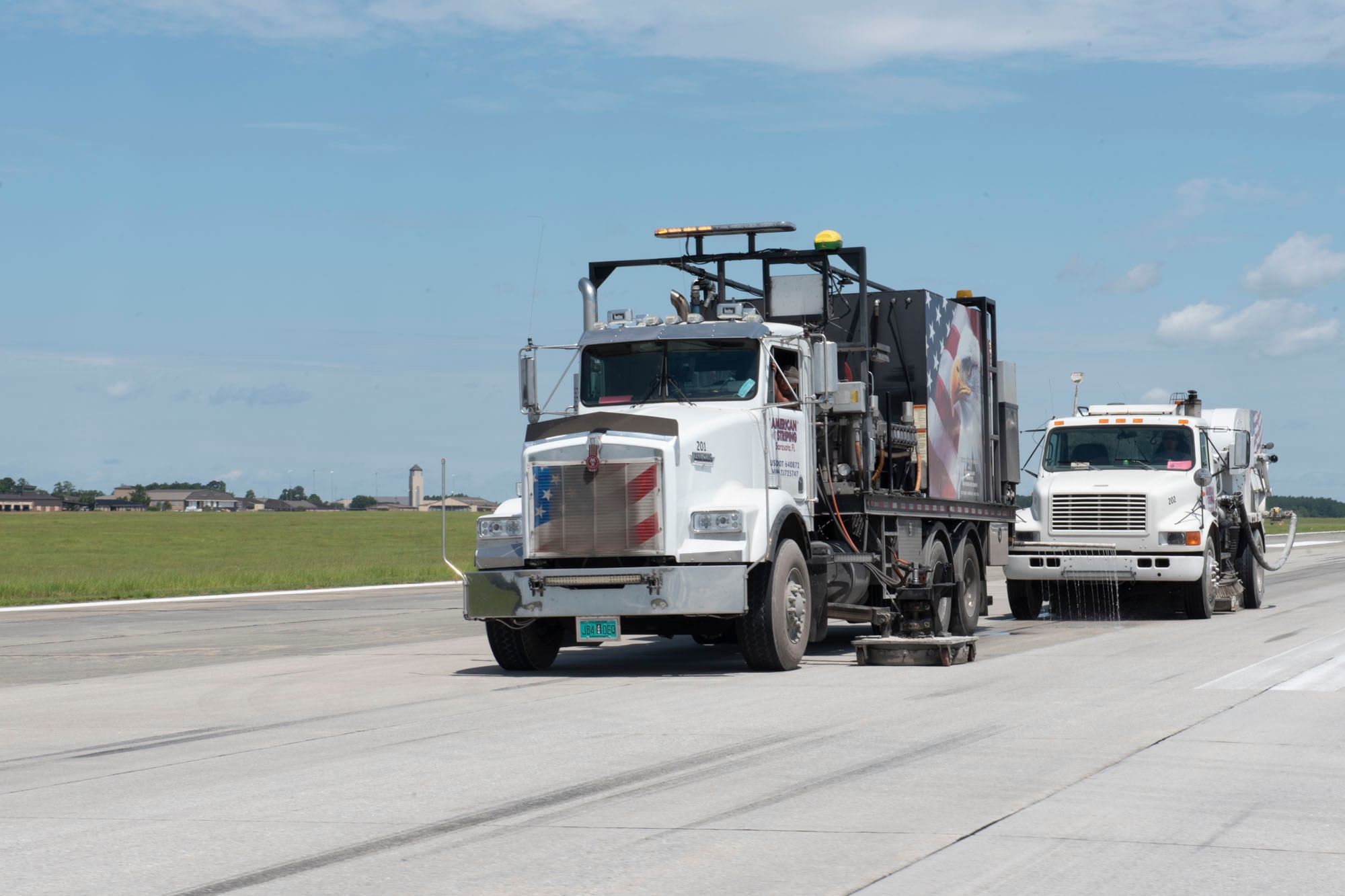 Photo of contractors removing rubber deposits from the runway