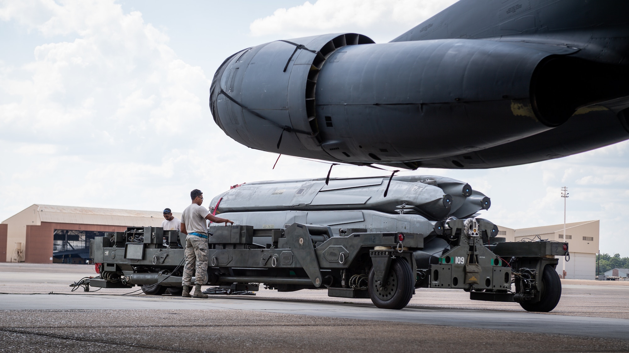 Load crew members of the 20th Aircraft Maintenance Unit prepare to load munitions on a B-52H Stratofortress during an Aircraft Monitor and Control test at Barksdale Air Force Base, La., Aug. 24, 2020. The test is performed every five to ten years to demonstrate the capability of the B-52 to provide the required voltage levels for the mission configuration in the AGM-86 air-launched cruise missile interface. (U.S. Air Force photo by Senior Airman Lillian Miller)