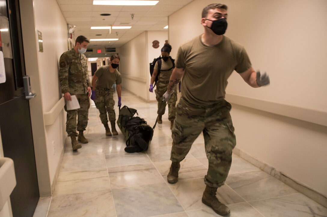 Medical personnel dragging a litter