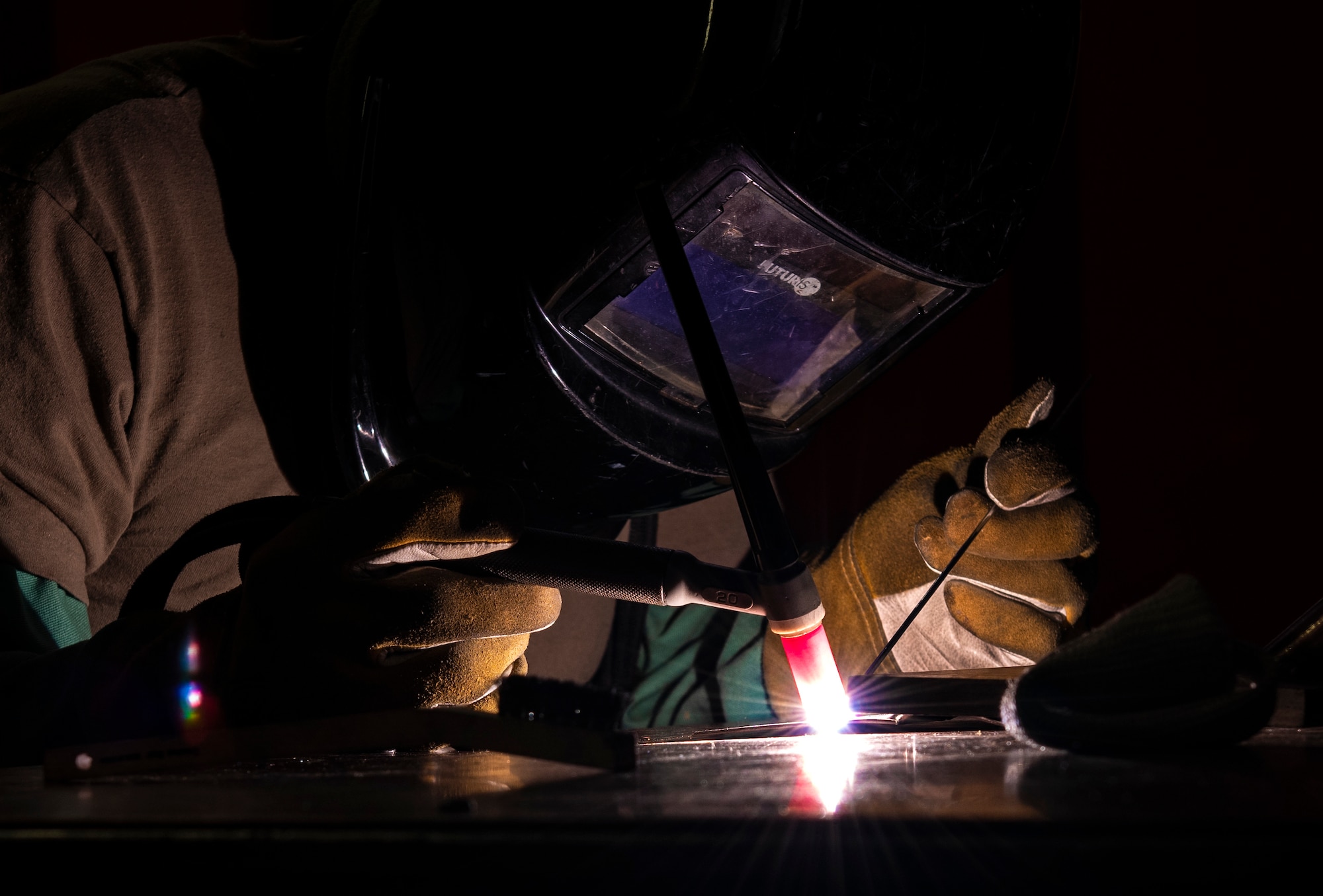 U.S. Air Force Staff Sgt. Richard Ababan, 48th Equipment Maintenance Squadron Fabrication Flight, performs tungsten inert gas (TIG) welding on a piece of metal at Royal Air Force Lakenheath, England, Sept. 15, 2020. The Fabrication Flight maintains the structural integrity of aircraft using specialized tools and equipment to repair damage and fabricate replacement parts, ensuring the 48th Fighter Wing remains a ready and capable force. (U.S. Air Force photo by Airman 1st Class Jessi Monte)