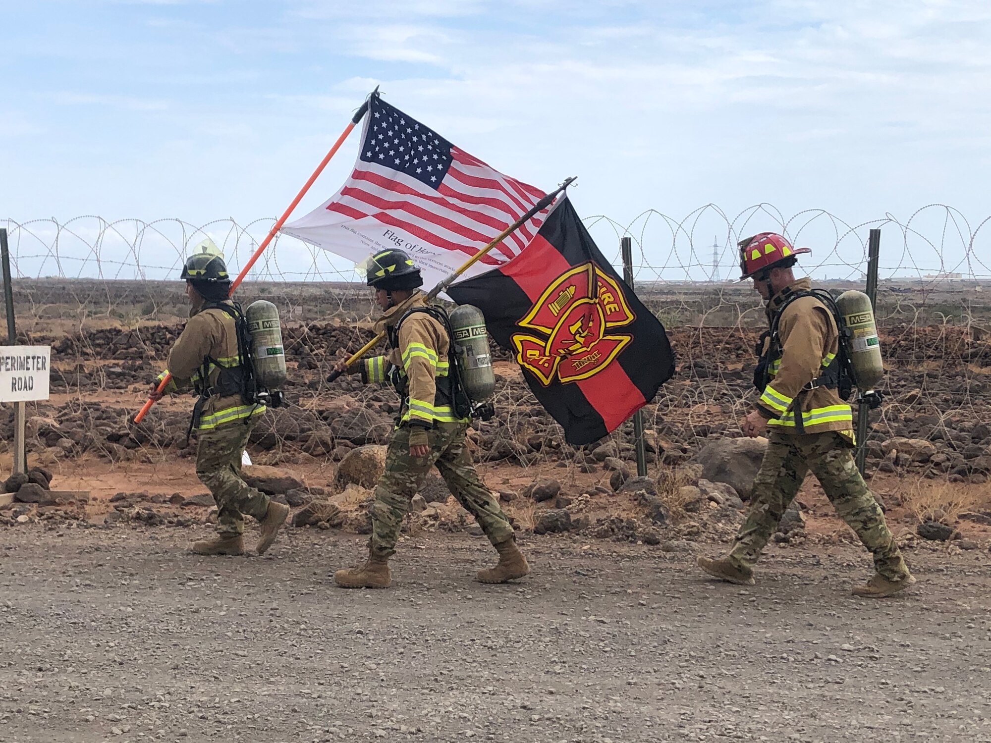 Firefighters assigned to the 726th Expeditionary Air Base Squadron participate in a ruck march at Chabelley Airfield, Djibouti, Sept. 11, 2020. The fire emergency service flight walked the perimeter of the base while carrying flags in remembrance of the 2,977 victims of the Sept. 11, 2001 attacks, with a special dedication to the 343 firefighters who tragically lost their lives that day. (Courtesy Photo)