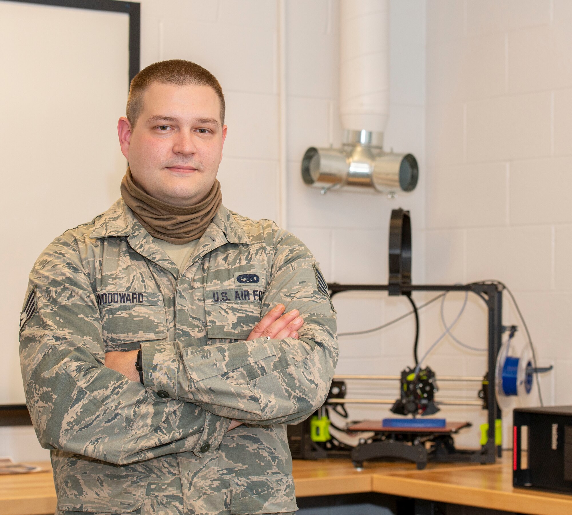 Staff Sgt. John Woodward, a metals technician with the 157th Maintenance Group, poses with a 3D printer, Pease Air National Guard Base, N.H, Sept. 3, 2020. Woodward used his background and education in metals technology to advance his shop’s use of the 3D printer, allowing technicians to create prototypes, plastic tools and molds for crafting multifaceted equipment. (U.S. Air National Guard photo by Staff Sgt. Victoria Nelson)