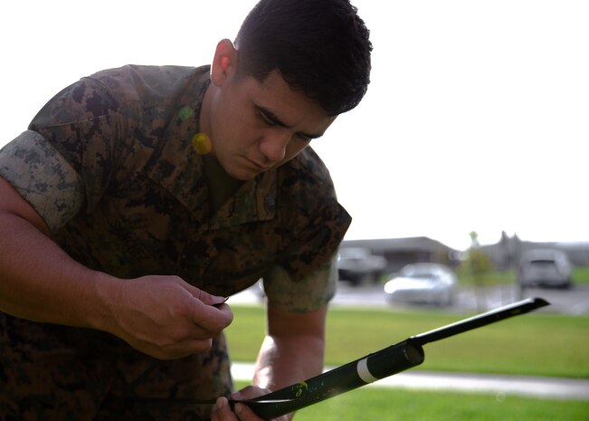 A U.S. Marine assembles his teams’ improved very high frequency antennae they created at Camp Lejeune, N.C., Sept. 16.