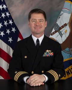 Cmdr. Ted Pledger, commanding officer of the Arleigh Burke-class guided-missile destroyer USS Cole (DDG  67), poses for a studio portrait.