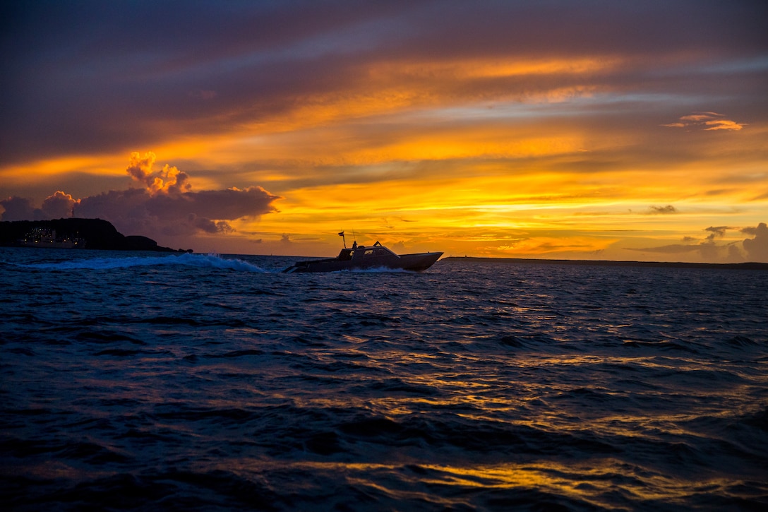 U.S. Navy Special Boat Team 12, Detachment Hotel, and U.S. Marines conduct a maritime training exercise aboard a combatant craft medium at Naval Base Guam, Aug. 3.