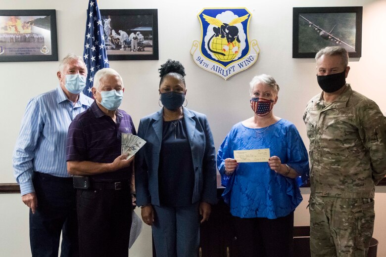 From left to right, Ron Durant and Dallas Godfrey, Corn and Sausage Roast chairmen; Angela Pedersen, 94th Airman and Family Readiness director; Marcia Miller, Dobbins Thrift Shoppe manager; and Col. Craig McPike, 94th Airlift Wing commander, pose for a photo at Dobbins Air Reserve Base, Ga., Sept. 17, 2020. The annual fundraiser brought in nearly $2,000 this year. (U.S. Air Force photo/Andrew Park)