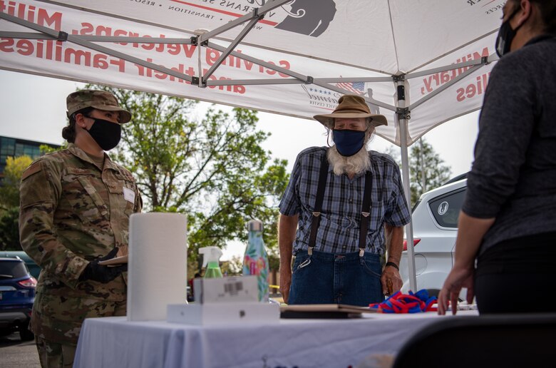 Staff Sgt. Kiara Kashner, United States Space Command executive assistant to the commandant, left, escorts Pete, retired, right, through the service booths at the 22nd Annual Homeless Veteran Stand Down in Colorado Springs, Colorado, Sept. 15, 2020. At the stand down, veterans visited service booths from the Rocky Mountain Human Services, Greccio Housing, Pikes Peak Employment Center, Mt. Caramel Veterans Center and more. (U.S. Air Force photo by Airman 1st Class Amanda Lovelace)