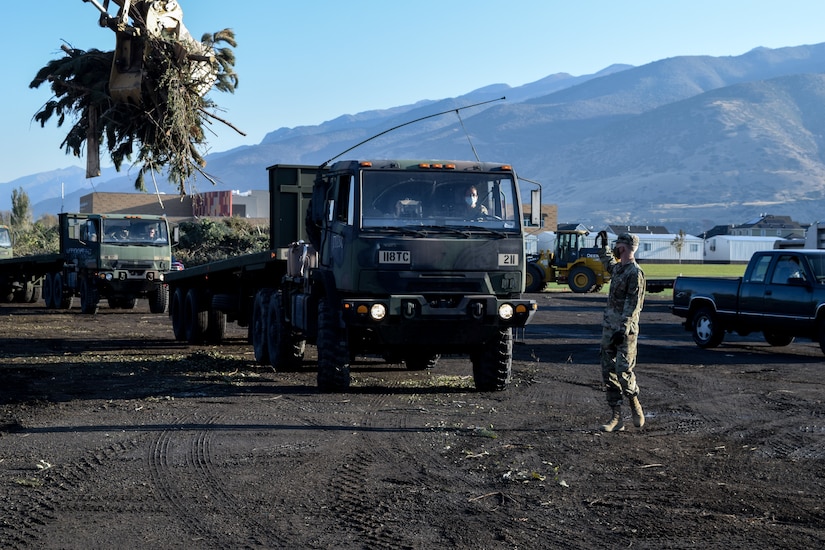 Utah Governor Gary Herbert stand with Soldiers at a debris waste collection site.