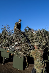 Utah Governor Gary Herbert stand with Soldiers at a debris waste collection site.