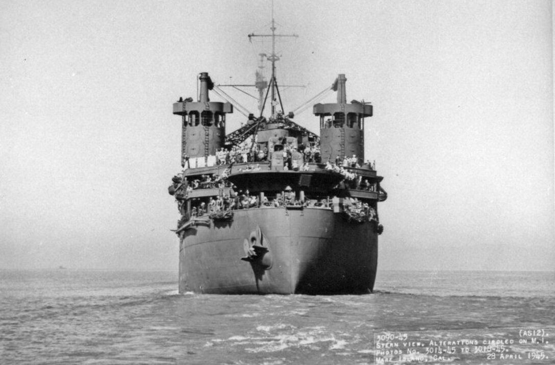 An old photo shows a ship sailing on the ocean.