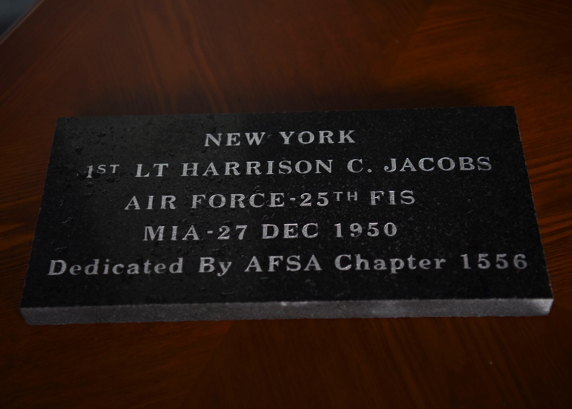 A commemorative brick is set on display during a POW/MIA Recognition Day ceremony at Osan Air Base, Republic of Korea, Sept. 16, 2020. The brick was dedicated to 1st Lt. Jacob Harrison, a pilot with the 25th Fighter Interceptor Squadron, who was declared missing in action after his aircraft was shot down over the Pacific Ocean during the Korean War. (U.S. Air Force photo by Senior Airman Denise Jenson)