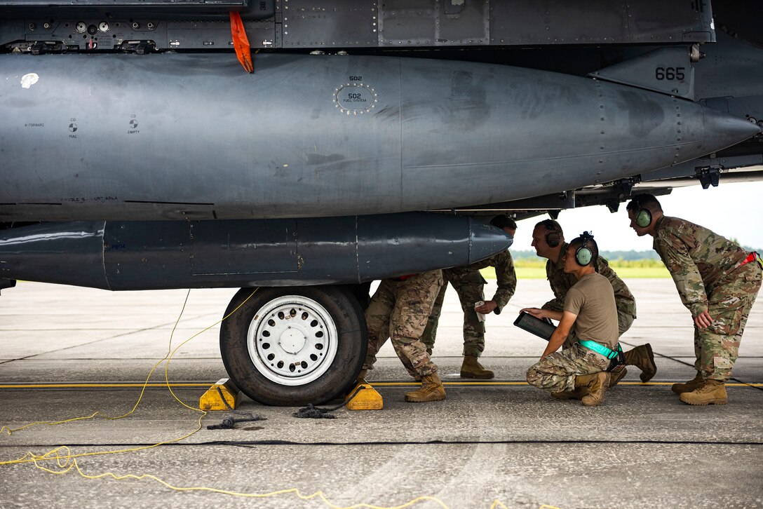 Photo of Airmen participating in hot-pit training.