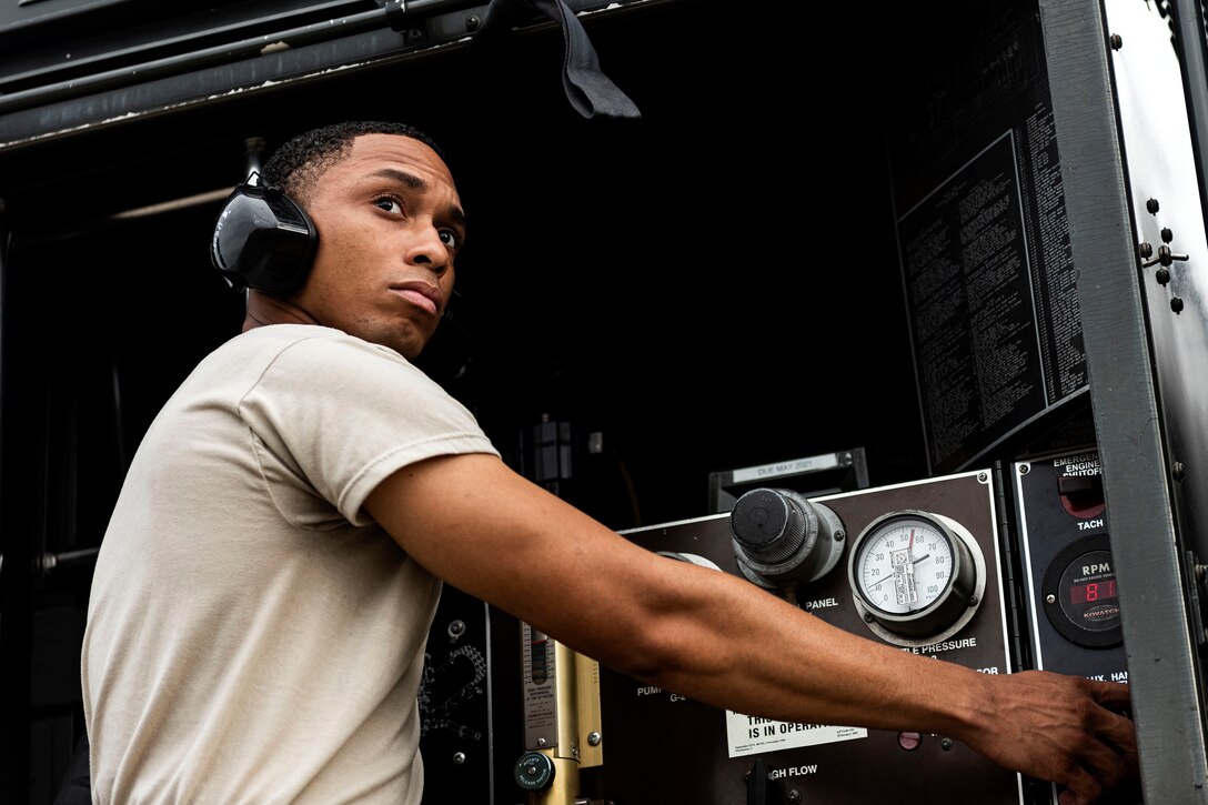 Photo of Airman monitoring refueling control panels.