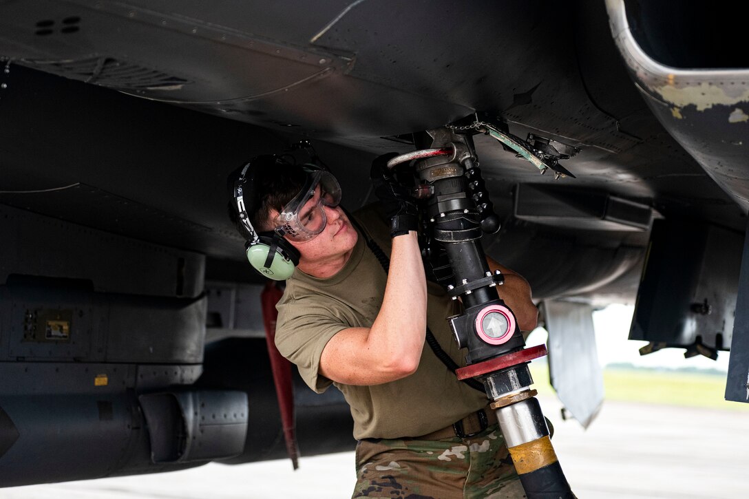 Photo of Airman removing a refueling nozzle.