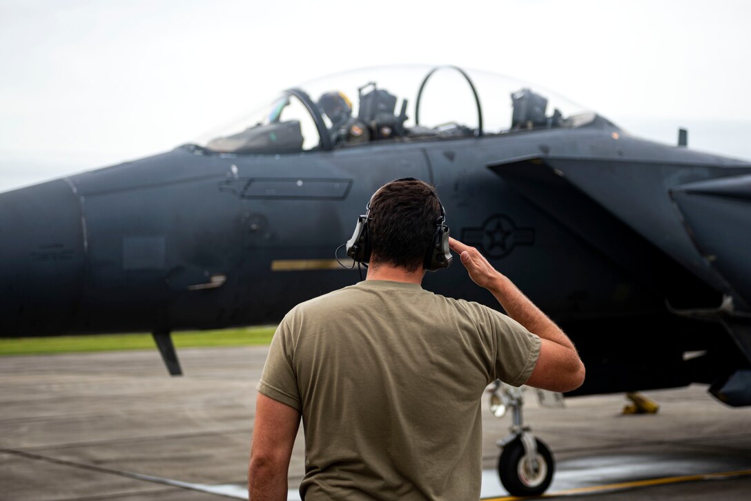Photo of Airman rendering a salute.