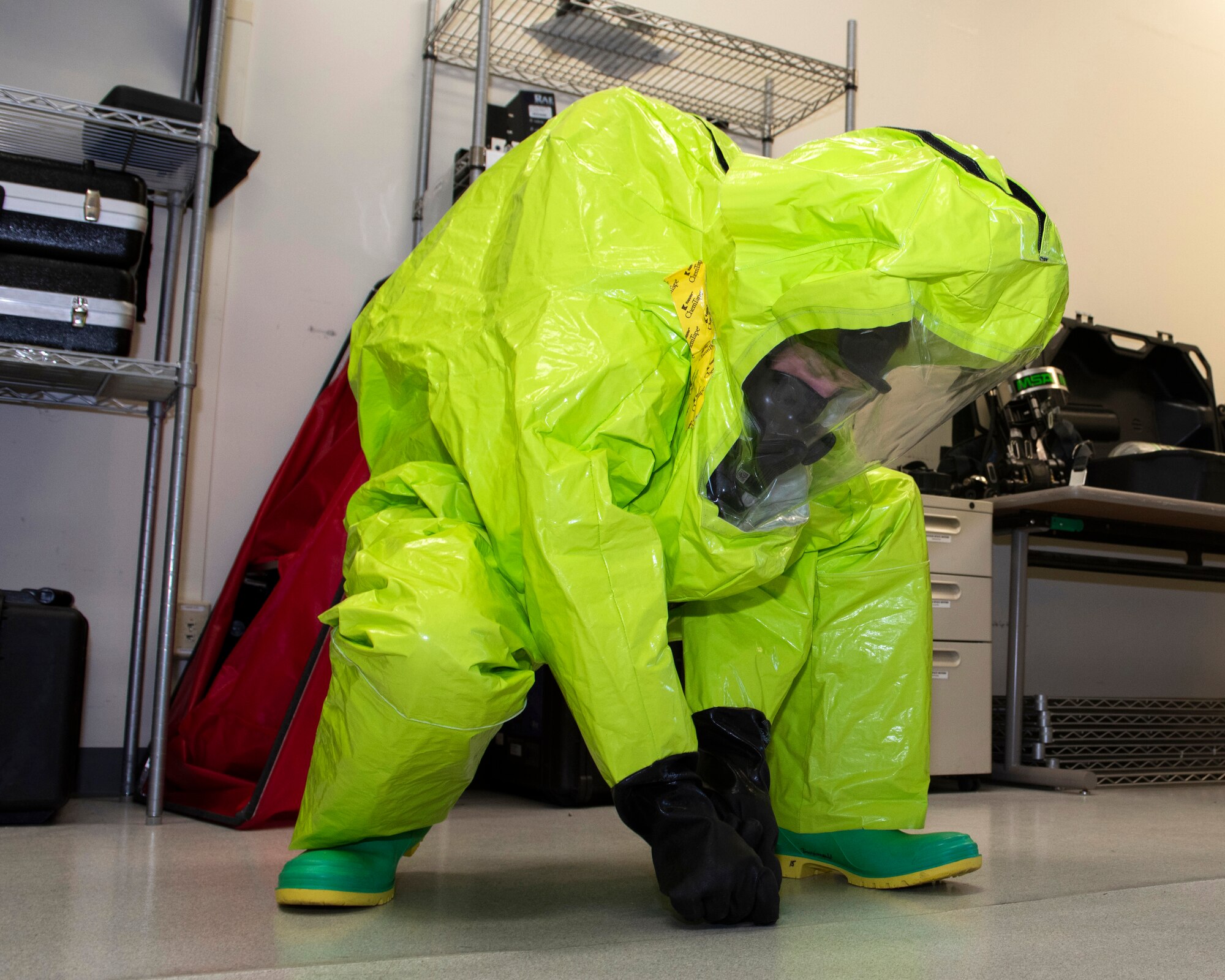 U.S. Air Force Airman Ethan Reyna, a 673d Aerospace Medicine Squadron bioenvironmental engineering journeyman, demonstrates the use of protective equipment during a 673d AMDS immersion tour at Joint Base Elmendorf-Richardson, Alaska, Sept. 8, 2020. Air Force Col. Kirsten Aguilar, Joint Base Elmendorf-Richardson and 673d Air Base Wing commander, familiarized herself with the 673d AMDS and its role in supporting readiness after  taking command of the installation July 14, 2020. The 673d AMDS maintains preventive medicine for the installation as well as flight readiness for the flying squadrons.