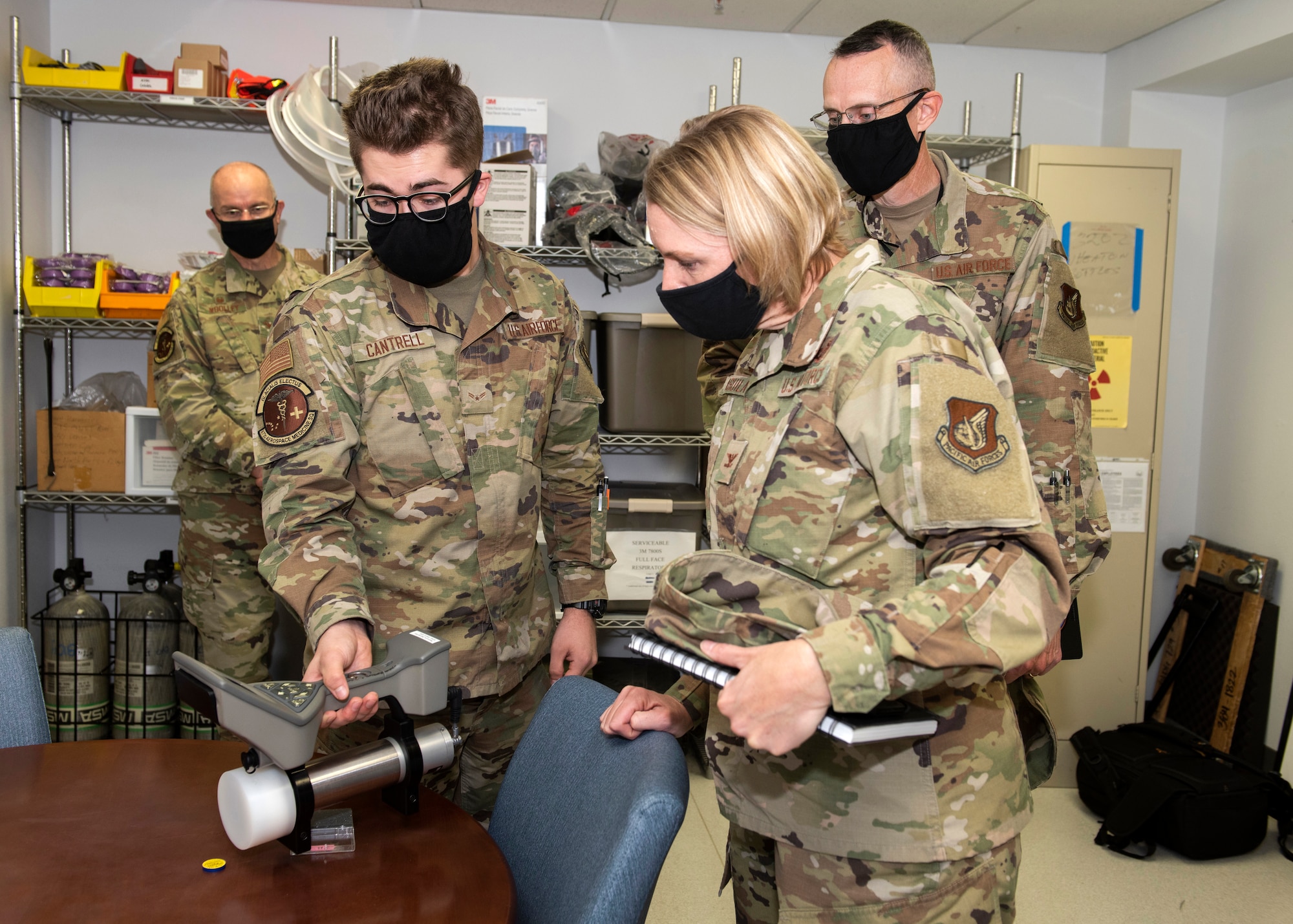U.S. Air Force Airman 1st Class Andrew Cantrell, left, a 673d Aerospace Medicine Squadron bioenvironmental engineering apprentice, demonstrates the use of emergency equipment for U.S. Air Force Col. Kirsten Aguilar, Joint Base Elmendorf-Richardson and 673d Air Base Wing commander, and U.S. Air Force Chief Master Sgt. Lee Mills, JBER and 673d ABW command chief, during a 673d AMDS immersion tour at Joint Base Elmendorf-Richardson, Alaska, Sept. 8, 2020. Aguilar familiarized herself with the 673d AMDS and its role in supporting readiness after  taking command of the installation July 14, 2020. The 673d AMDS maintains preventive medicine for the installation as well as flight readiness for the flying squadrons.
