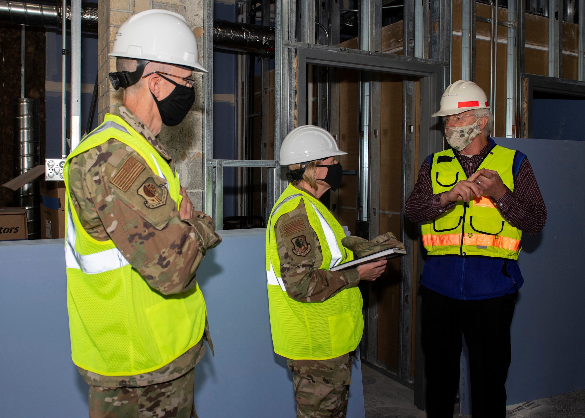 Jeffrey Liddle, 673d Medical Group hospital engineer, right, briefs U.S. Air Force Col. Kirsten Aguilar, Joint Base Elmendorf-Richardson and 673d Air Base Wing commander, and U.S. Air Force Chief Master Sgt. Lee Mills, JBER and 673d ABW command chief, on new construction and repairs to the Flight Medicine building during a 673d Aerospace Medicine Squadron immersion tour at Joint Base Elmendorf-Richardson, Alaska, Sept. 8, 2020. Aguilar familiarized herself with the 673d AMDS and its role in supporting readiness after  taking command of the installation July 14, 2020. The 673d AMDS maintains preventive medicine for the installation as well as flight readiness for the flying squadrons.
