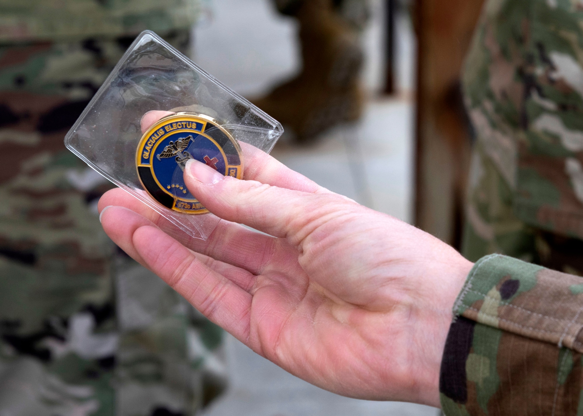 U.S. Air Force Col. Kirsten Aguilar, Joint Base Elmendorf-Richardson and 673d Air Base Wing commander, receives a 673d Aerospace Medicine coin during an immersion tour at Joint Base Elmendorf-Richardson, Alaska, Sept. 8, 2020. Aguilar familiarized herself with the 673d AMDS and its role in supporting readiness after  taking command of the installation July 14, 2020. The 673d AMDS maintains preventive medicine for the installation as well as flight readiness for the flying squadrons.