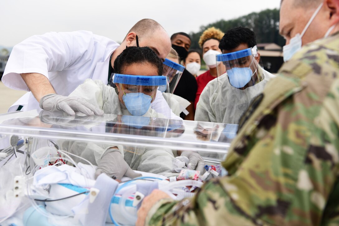 Airmen from Kadena Air Base, Japan’s 18th Aeromedical Evacuation Squadron prepare to transport Nehemiah, son of Davion and Rejeya Miller, during a specialized neo-natal care medical evacuation at Osan Air Base, Republic of Korea, Sept. 17, 2020. Nehemiah is being transported to Hawaii’s Tripler Army Medical center for specialized neo-natal care due to complications due to a premature birth.  (U.S. Air Force photo by Senior Airman Noah Sudolcan)