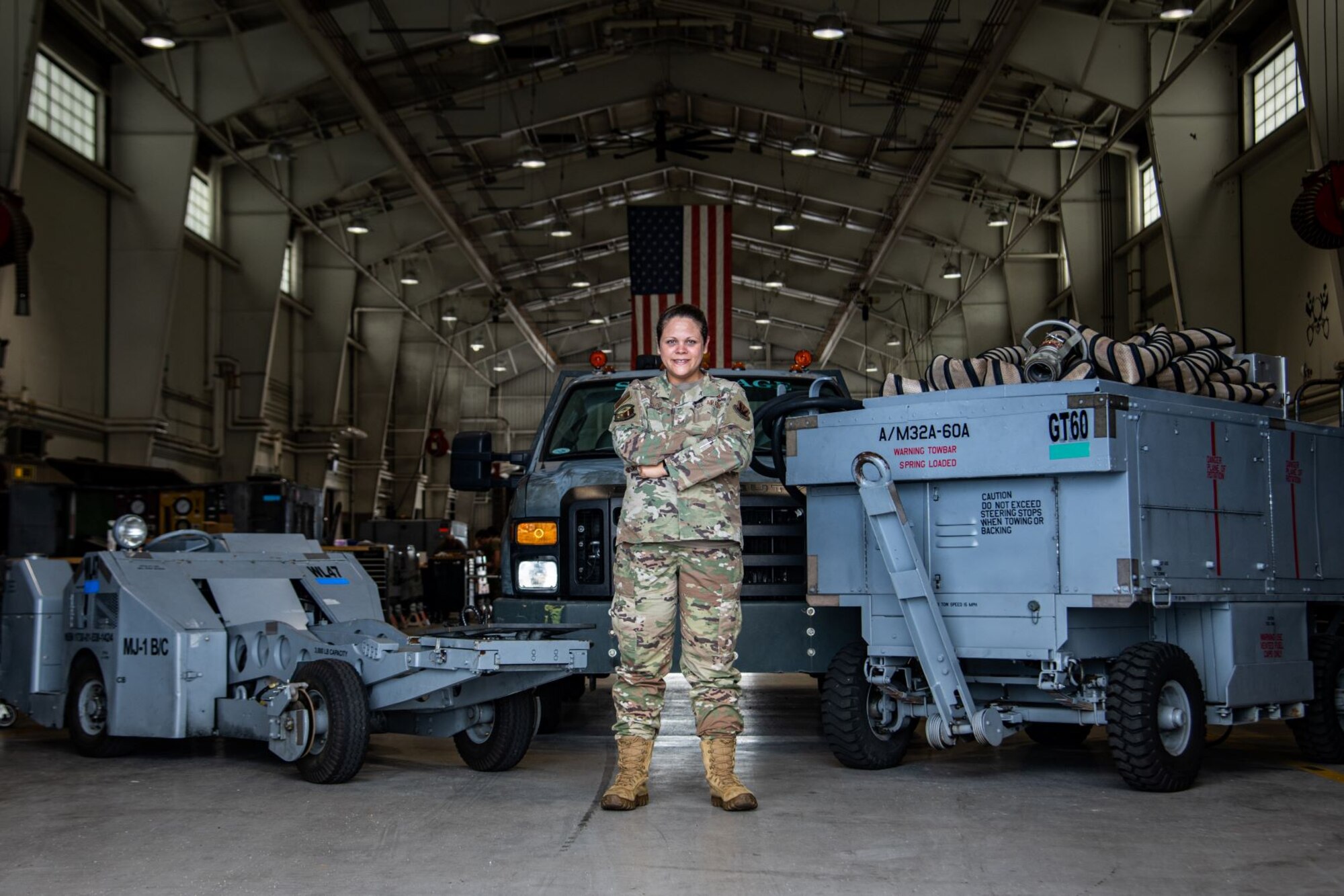 Tech. Sgt. Natalia Wood, 20th Equipment Maintenance Squadron aerospace ground equipment maintenance Airman, poses in her workplace while showcasing the 20th Fighter Wing assets she maintains at Shaw Air Force Base, S.C., Aug. 25, 2020. In her role on the women’s initiative team, she helped champion the effort to ensure practical lactation spaces and breastmilk storage for women in the Department of the Air Force. (U.S. Air Force photo by Staff Sgt. Sean Sweeney)