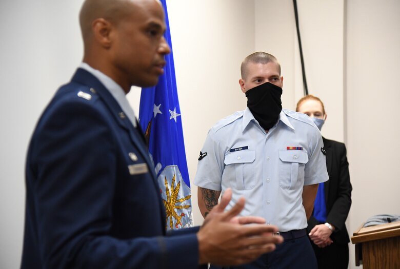 U.S. Air Force Airman Joshua Balmer, 737th Training Group basic military training graduate and son of fallen Air Force Office of Special Investigations Special Agent Ryan Balmer, stands as Special Agent Shannon Robinson, AFOSI Detachment 407 commander, delivers remarks during a presentation ceremony inside the Levitow Training Support Facility at Keesler Air Force Base, Mississippi, Sept. 11, 2020. Balmer was presented mementos by the detachment following his graduation from BMT. (U.S. Air Force photo by Kemberly Groue)
