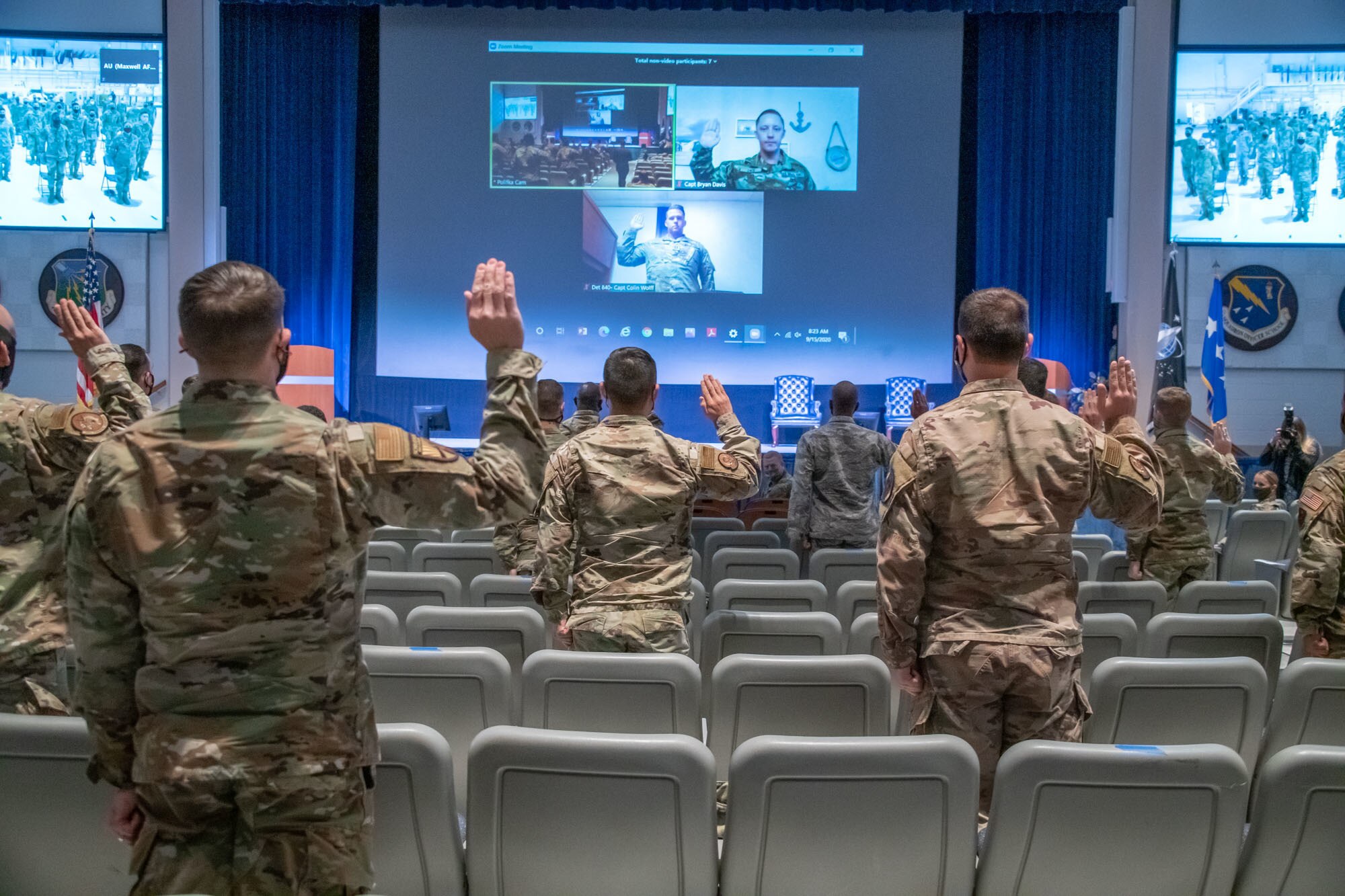 Air Force and Space Force officers raise their hands to take a ceremonial oath of office during a virtual commissioning ceremony Sept. 15, 2020, on Maxwell Air Force Base, Alabama. U.S. Space Force Chief of Space Operations Gen. John W. "Jay" Raymond led the officers in the oath following his virtual presentation at the Air Force Association's 2020 Virtual Air, Space and Cyber Conference. Following the oath, the general welcomed more than 300 officers stationed at Air University and around the world transfering to the Space Force. (U.S. Air Force photo by Trey Ward)