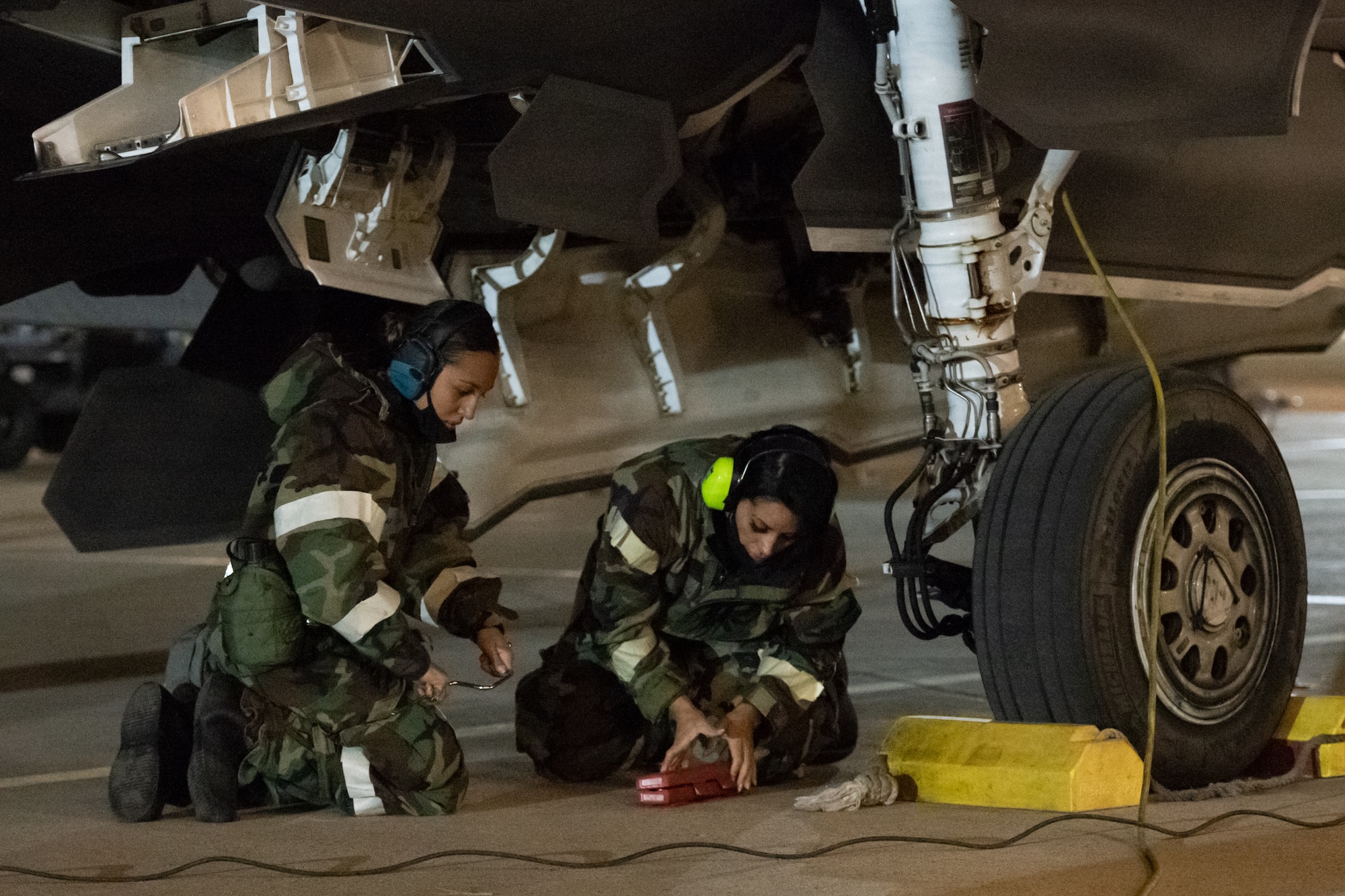 Senior Airman Deneen Clark and Staff Sgt. Aften Garcia, weapon loaders in the 419th Aircraft Maintenance Squadron, prepare an F-35A Lightning II to receive flares during an exercise