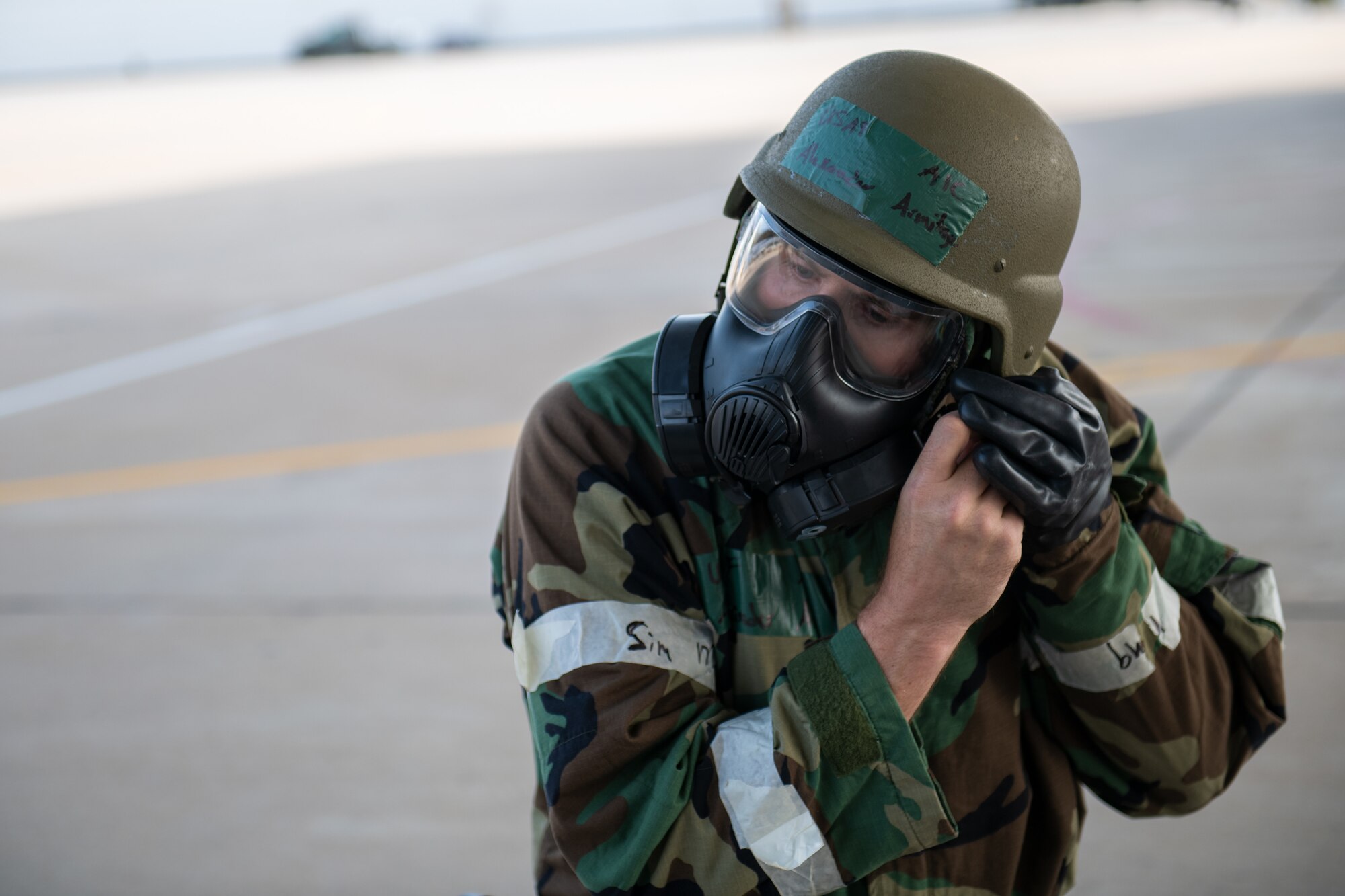 Airman 1st Class Alexander Armitage, avionics technician in the 419th Aircraft Maintenance Squadron, dons mission oriented protective posture gear during an exercise