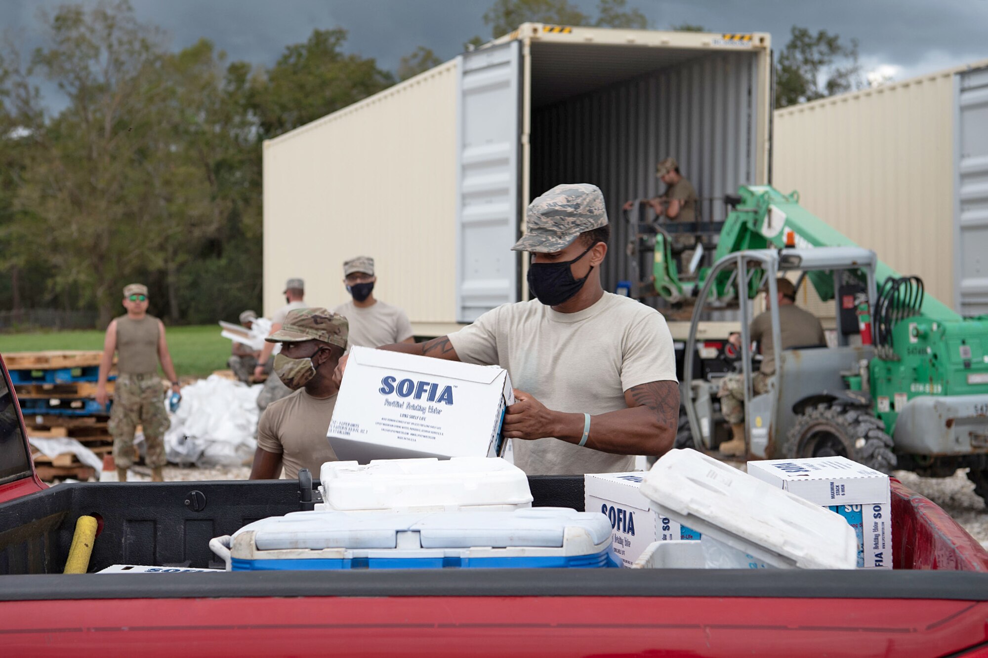 Airmen from the 159th Fighter Wing, Louisiana Air National Guard, load supplies in vehicles of residents affected by Hurricane Laura in Kinder, La., Aug 29, 2020.