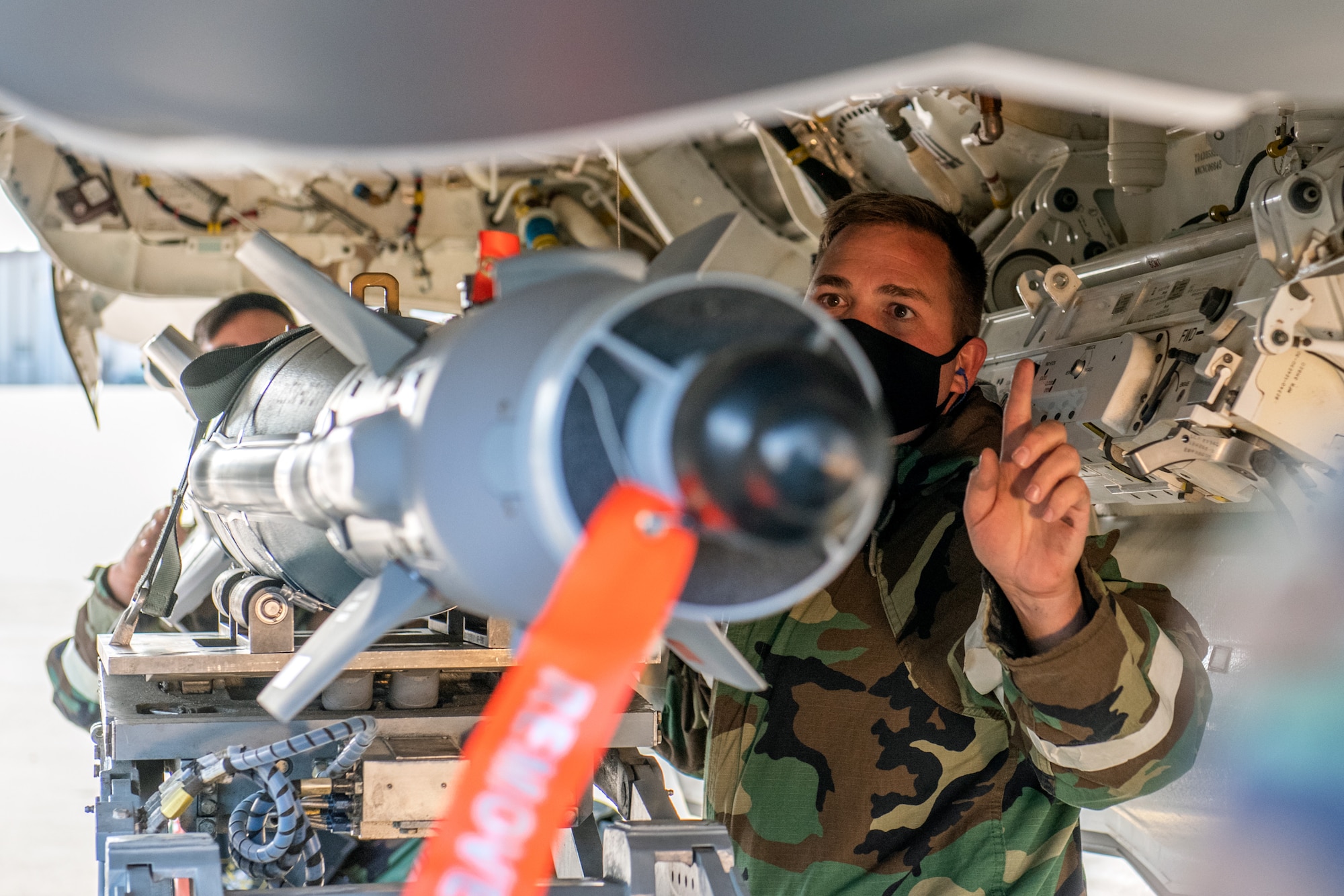 Tech. Sgt. Brian Hansen, a reservist in the 419th Aircraft Maintenance Squadron, guides a GBU-39 bomb into an F-35A Lightning II weapons bay