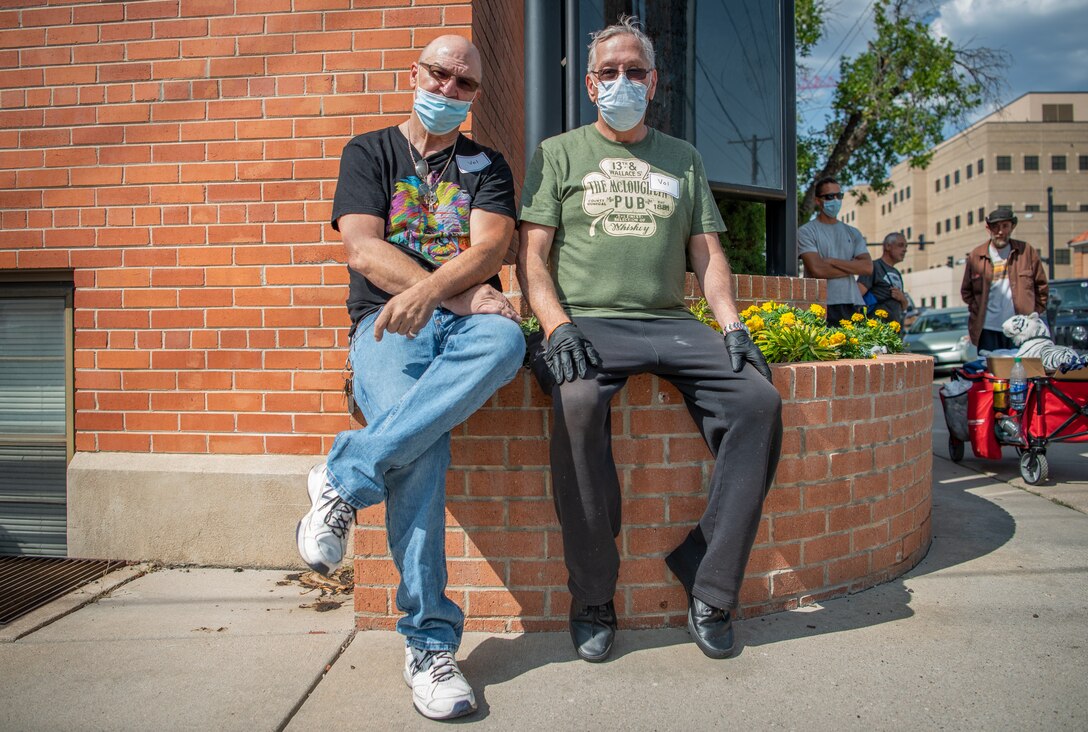 Steven, retired, left, and Eubert, retired, right, pose for a photo during the 22nd Annual Homeless Veteran Stand Down in downtown Colorado Springs, Colorado, Sept. 15, 2020. At last year’s stand down, Steven and Eubert were homeless and came to the event seeking aid. At that event, they were able to connect with a program that helped them get back on their feet. This year, they returned to the event as volunteers. (U.S. Air Force photo by Airman 1st Class Amanda Lovelace)