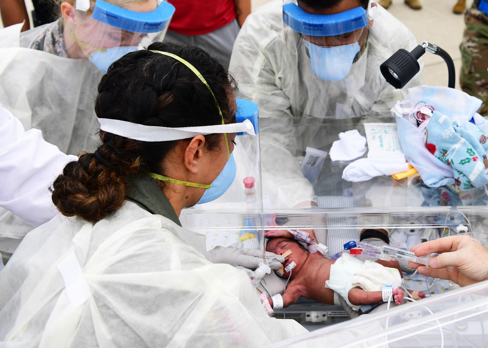 Airmen from Kadena Air Base, Japan’s 18th Aeromedical Evacuation Squadron, prepare to transport Nehemiah, son of Davion and Rejeya Miller, during a specialized neo-natal care medical evacuation at Osan Air Base, Republic of Korea, Sept. 17, 2020. Nehemiah was being transported to Hawaii’s Tripler Army Medical center for specialized neo-natal care due to complications from a premature birth. (U.S. Air Force photo by Senior Airman Noah Sudolcan)