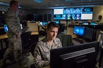 Airmen work on computers.