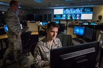 Airmen work on computers.