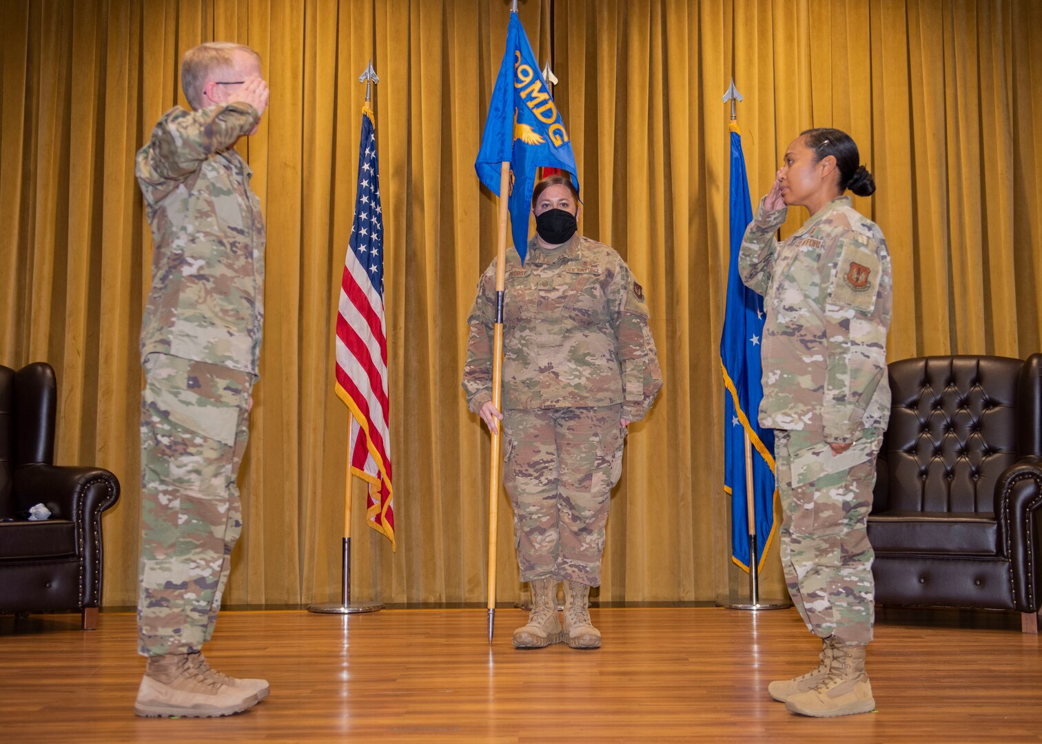 The 39th MDG commander and the 39th HCOS commander salute each other.