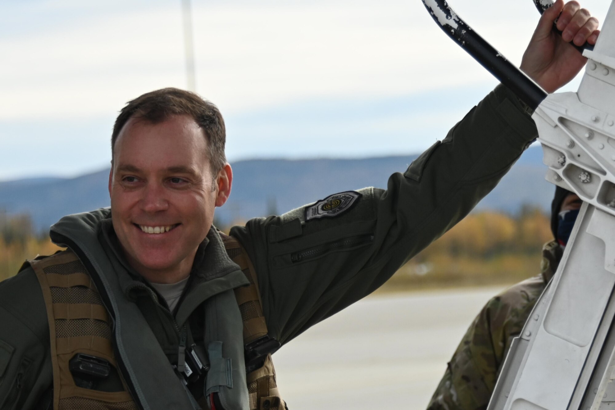 An Airman smiles as he boards a B-1 Lancer