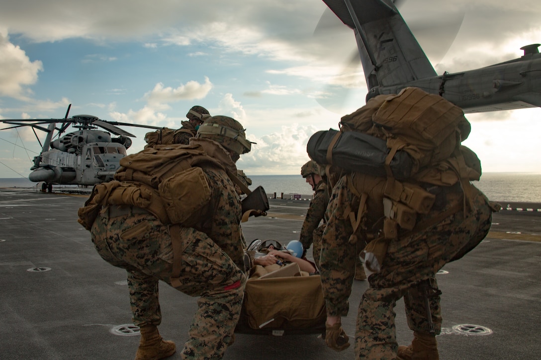 Marines and Sailors with the 31st Marine Expeditionary Unit transport simulated casualties during a mass casualty drill, or Nightingale, aboard amphibious assault ship USS America (LHA 6) in the Philippine Sea, Sept. 10, 2020.