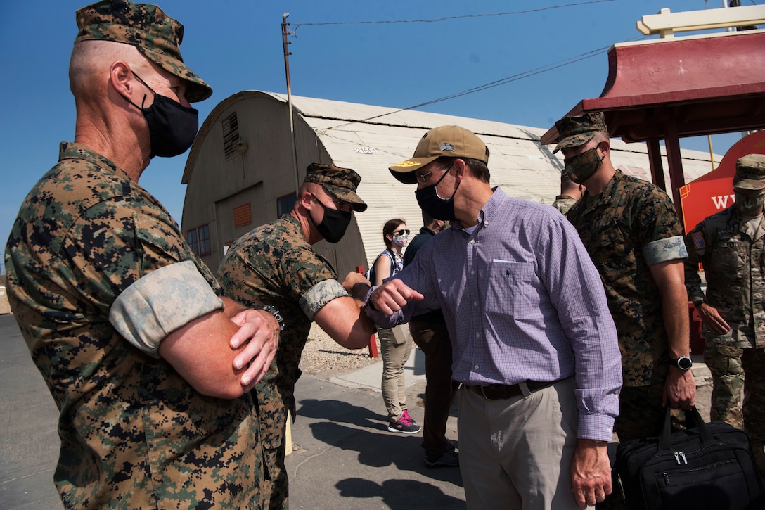 Defense Secretary Dr. Mark T. Esper bumps elbows with a Marine.