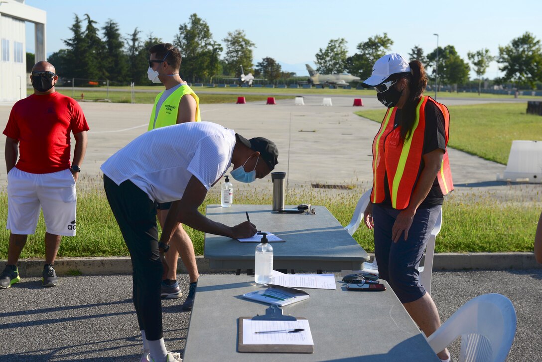 A runner signs in to the Run for the Dream 5k at Aviano Air Base, Italy, Sept. 12, 2020. Organizers strictly enforced social distancing guidelines and mask wear during the event. (U.S. Air Force photo by Tech. Sgt. Tory Cusimano)