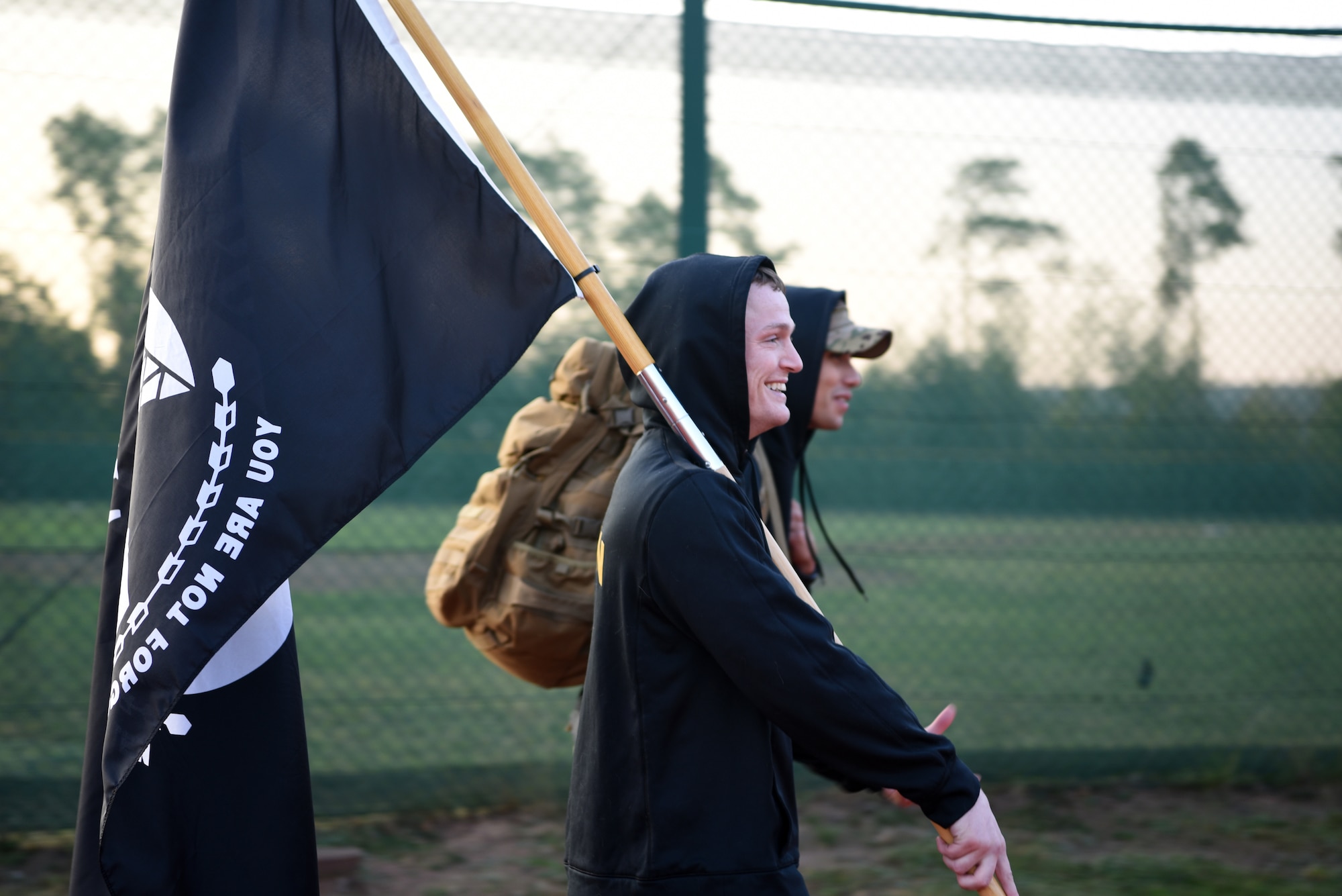 U.S. Air Force Ravens, assigned to the 86th Security Forces Squadron, walk laps around the base track while carrying POW/MIA flags at Ramstein Air Base, Germany, Sept. 18, 2020.