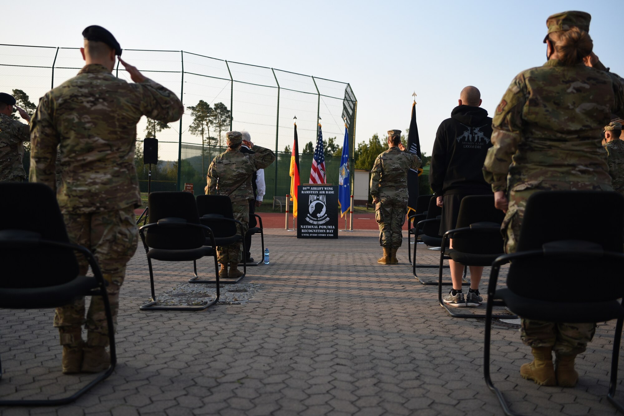 U.S. Air Force Airmen salute during the national anthem, signifying the beginning of the National POW/MIA Recognition Day ceremony at Ramstein Air Base, Germany, Sept. 18, 2020.