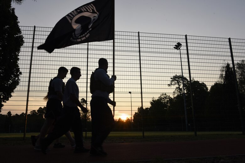 U.S. Air Force Airmen, assigned to the 86th Security Forces Squadron, carry the POW/MIA flag around the base track to commemorate National POW/MIA Recognition Day at Ramstein Air Base, Germany, Sept. 18, 2020.