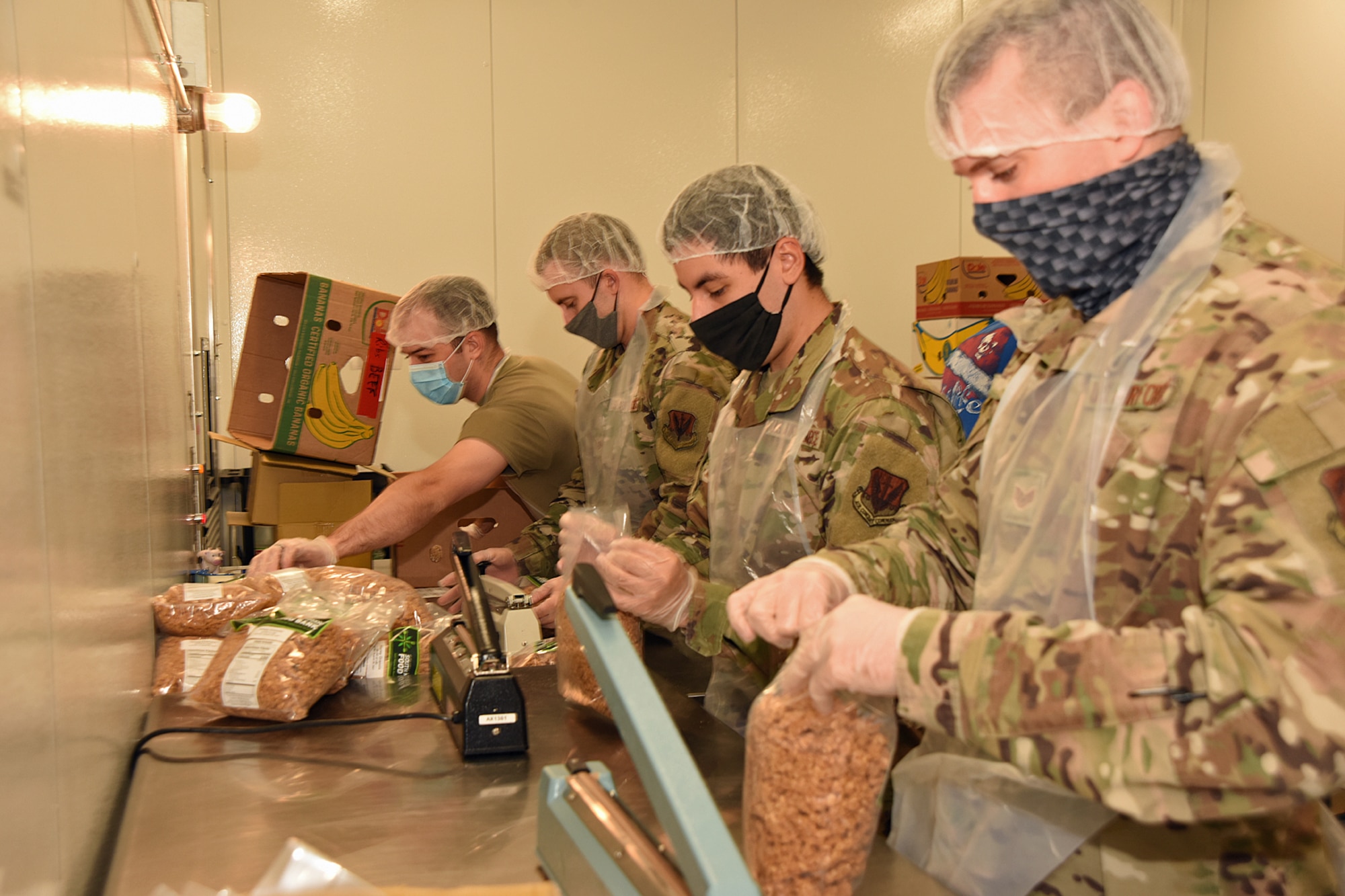 Members from the 110th Wing, Battle Creek Air National Guard Base, Mich., now part of the Michigan National Guard COVID-19 Joint Task Force, work with the Food Bank of South Michigan, labeling, filling, and weighing bags of donated granola for local food pantries in Battle Creek, Sep. 11, 2020. The Food Bank warehouse serves 8 counties consisting of 285 food pantries in southern Michigan. Since March, Michigan National Guard teams have supported food banks across Michigan, distributing more than 7 million pounds of food to local communities. (U.S. Air National Guard photo by Master Sgt. David Kujawa)