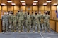 A group of Airmen standing in a courtroom.